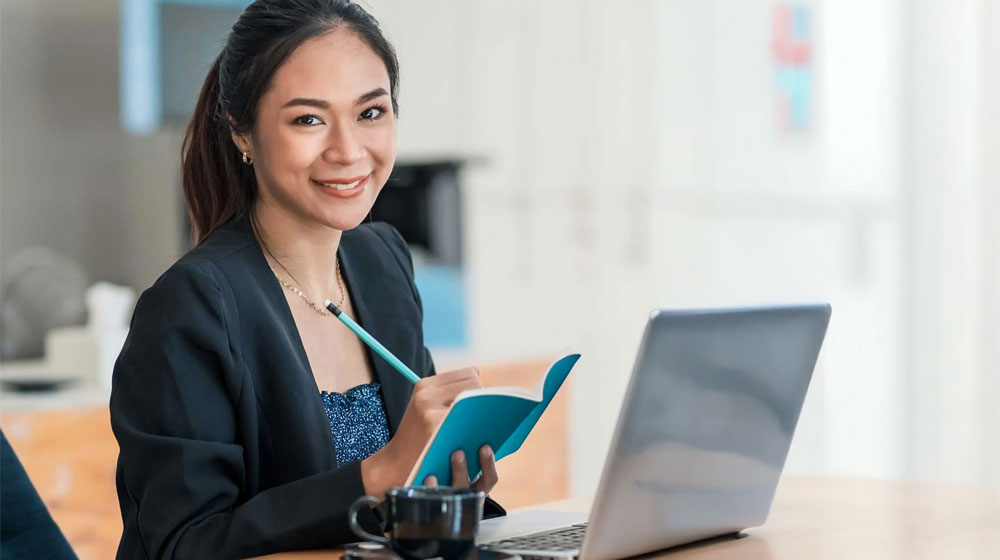 Professional virtual assistant working with laptop and notebook